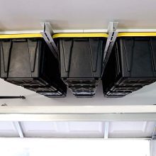 Overhead garage storage rack securely holding multiple bins, showcasing its industrial steel frame and efficient use of ceiling space.