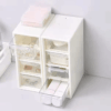 Compact plastic storage box with 4 drawers, ideal for organizing office supplies, makeup, or small items, perfect for desk or vanity use.