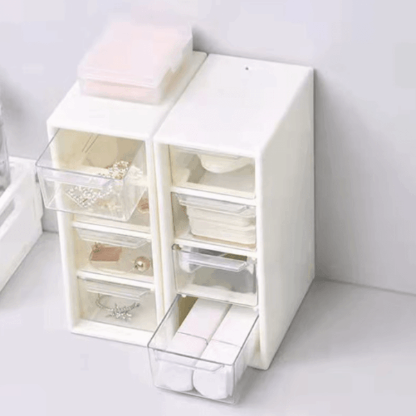 Compact plastic storage box with 4 drawers, ideal for organizing office supplies, makeup, or small items, perfect for desk or vanity use.