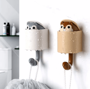 Wall-mounted squirrel hook with hidden squirrel that pops out, designed for holding keys, hats, and accessories in a playful and functional way. 