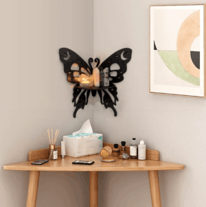 Butterfly-shaped wooden wall shelf with moon and star cutouts, mounted in a corner with decor items. 