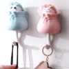 Lucky cat decorative wall hook with adhesive backing, designed for hanging keys, hats, and small items with a fun and functional design. 