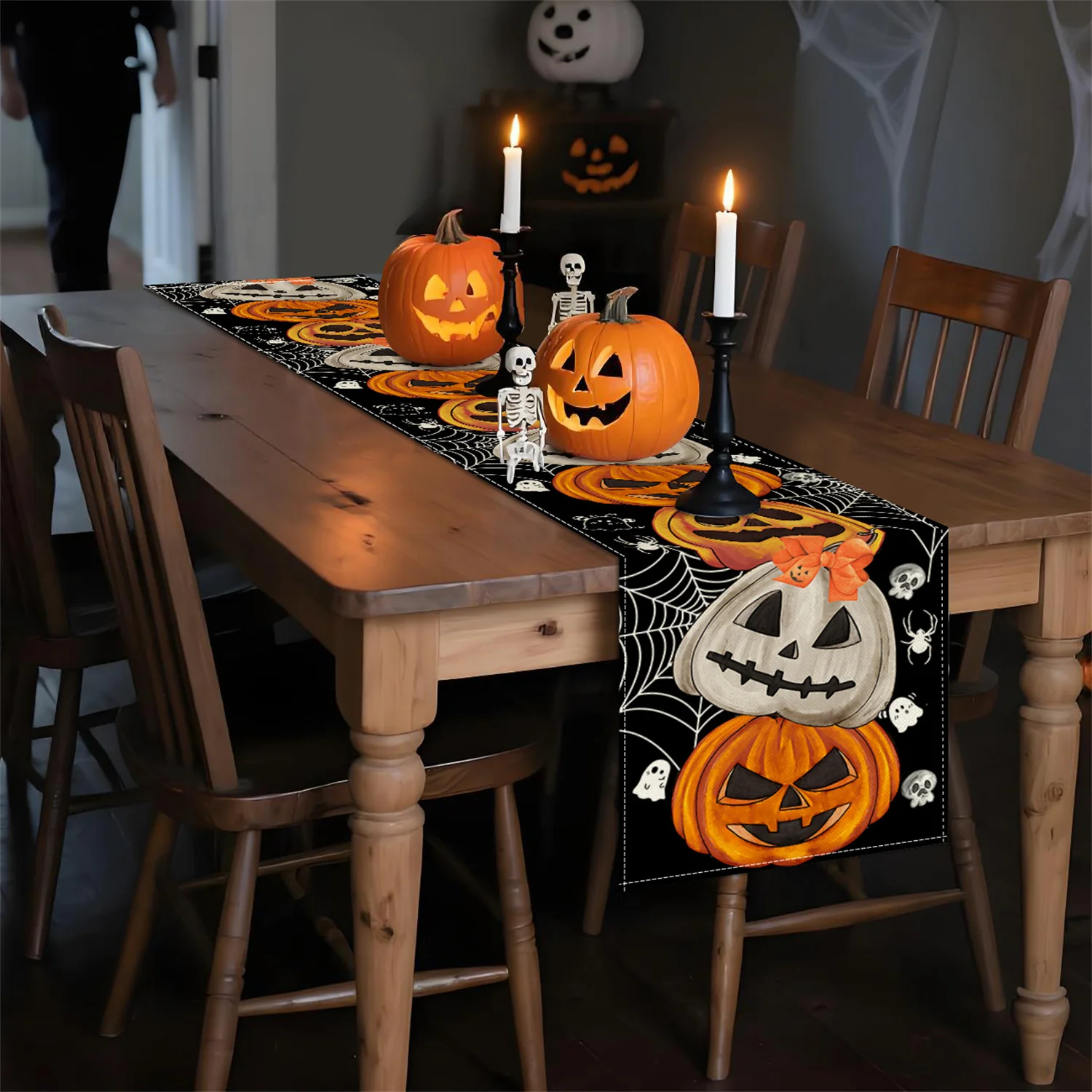Halloween Table Setting with Table Runner Lit Candles Jack O Lanterns and Skeletons